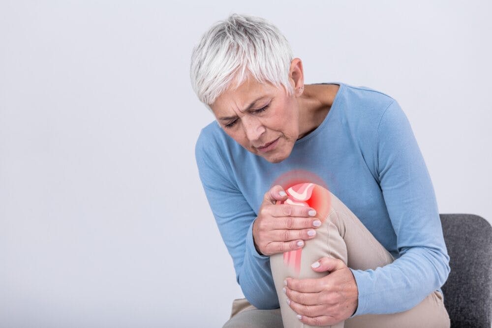 senior woman suffering from pain in her knee